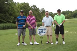 tmba golf tournament 2016 4 men posing with sign priority golf green v2
